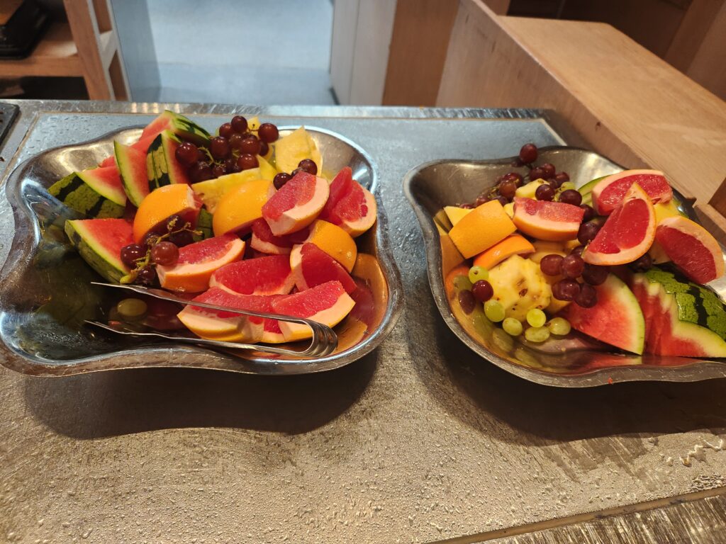Finnair Business Lounge (non-schengen) Helsinki Food and Nutrition Review (updated 2024) - finnair business lounge Bowls of sliced fruit and grapes Finnair business lounge